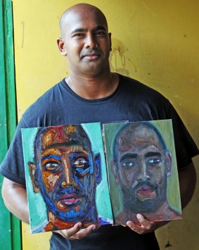 Myuran Sukumaran holding his self-portraits painted in the Kerobokan jail.