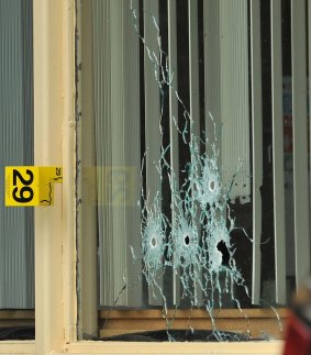 Bullet holes show in a window of a Days Inn Hotel office from a shooting early on Thursday morning in Tennessee.