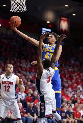Jonah Bolden of the UCLA Bruins shoots over Kadeem Allen of the Arizona Wildcats during a college basketball game in February. 