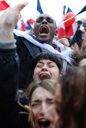 Supporters of French independent centrist presidential candidate, Emmanuel Macron react outside the Louvre museum in Paris.