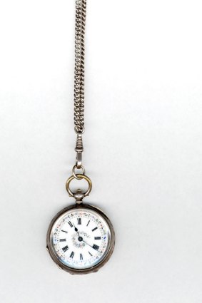 Antique pocket watch on golden chain.