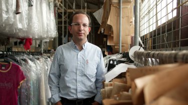 Specialty Fashion chief executive Gary Perlstein is still counting the cost of his Rivers acquisition, but losses have halved.