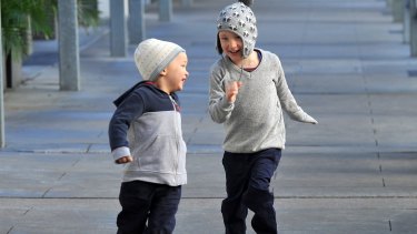 Two young boys are seen playing as cold weather hits south-east Queensland.
