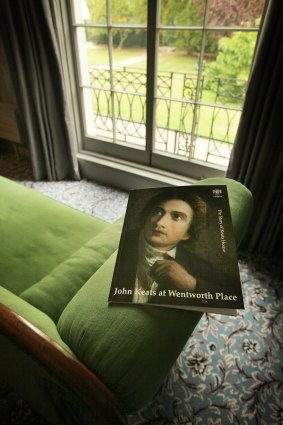 A brochure showing a portrait of John Keats sits on a chaise lounge.