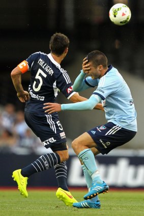 Mark Milligan and Terry Antonis collide during the A-League match between Melbourne Victory and Sydney FC on Saturday.