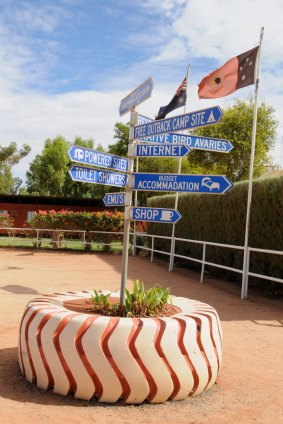 A sign showing directions around the Curtin
Springs fuel stop and camp site.