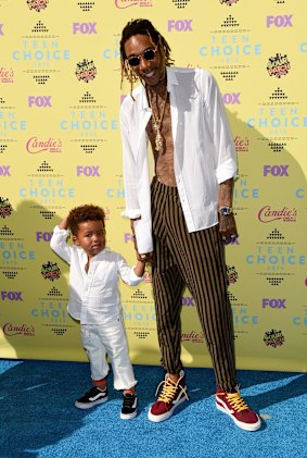 Sebastian Taylor Thomaz (L) and rapper Wiz Khalifa.