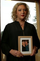 Health Minister Jill Hennessy holds a photo of her mother who has MS.