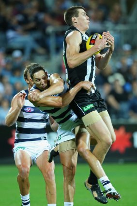 American rookie Mason Cox of the Magpies marks in front of Harry Taylor of the Cats.