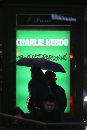 A billboard with the <i>Charlie Hebdo</i> cover in Paris.