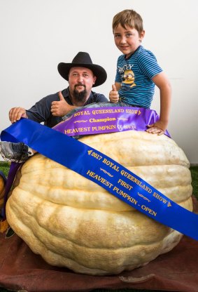 Tony Frohloff with his son Riley and his champion pumpkin weighing in a 257 kilograms.