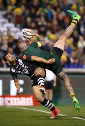 Josh Dugan scores a try as New Zealand's Jordan Kahu attempts to defend the line during The Test in Canberra, Australia.