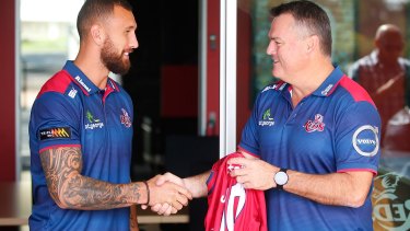 Back in the fold: Quade Cooper receives a Reds jersey from coach Nick Stiles after signing a three-year contract with the ARU and the Queensland side.
