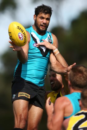 Port Adelaide ruckman Paddy Ryder gets some air over teammates at training.