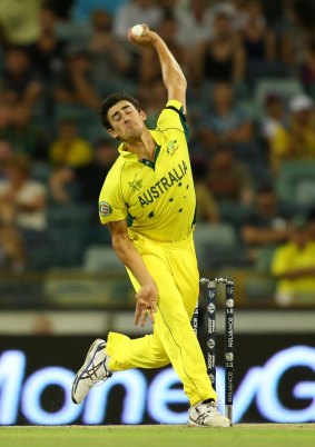 Over she goes: Mitch Starc bowls during the match against Afghanistan.
