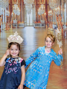Children pose in front of a photograph from the  Palace of Versailles in France, heralding not only the National Gallery of Australia's next blockbuster, Versailles: Treasures from the Palace, but the gallery's plans to open a permanent, free play space.