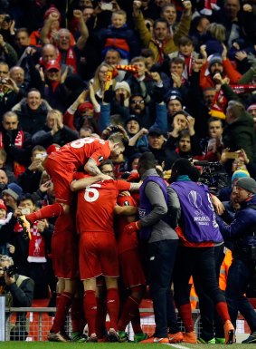 Liverpool players celebrate after Firmino's goal. 
