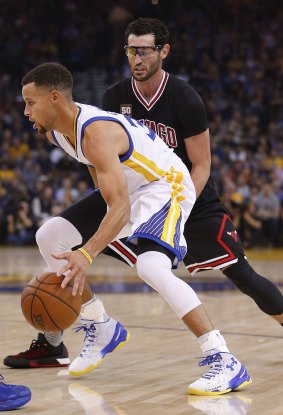 Smooth operator: Golden State Warriors guard Stephen Curry dribbles around Chicago Bulls rival Kirk Hinrich.