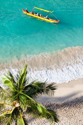 An outrigger canoeing on Waikiki Beach celebrates Hawaiian water culture. 