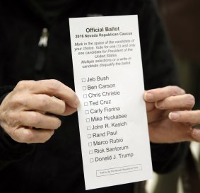 A voter shows a caucus ballot paper  in Reno, Nevada.  