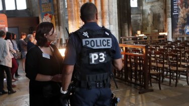 A police officer looks on during a mass in tribute to priest Jacques Hamel who was killed by two attackers at the Saint Etienne church, in the Cathedral Notre Dame in Rouen, Normandy, France.