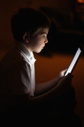 Child reading on iPad.