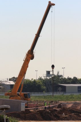 A crane remains motionless at Eagle Farm on Friday morning as the accident site is investigated.