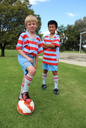 Yuryo Nakamura, 9, and Tommy Golack, 8, are part of Woden Valley Football Club, which has the ACT's biggest contingent of juniors.