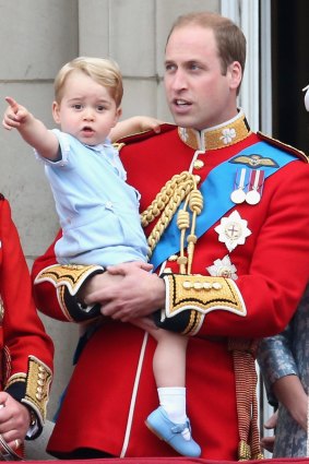 Prince George on the balcony of Buckingham Palace with Prince William.