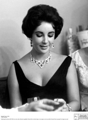 Actor Elizabeth Taylor wears her  ruby and diamond necklace and earrings (1958) in Las Vegas.