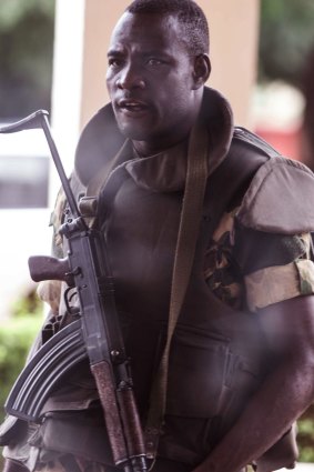 A soldier stands guard outside a hotel in Ouagadougou where talks between Burkina Faso's factions were being held.