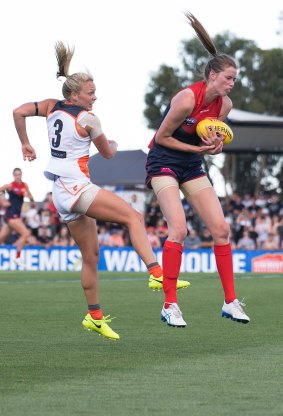 Erin Hoare marks in front of Giants player Phoebe McWilliams.