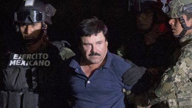 Mexican drug lord Joaquin "El Chapo" Guzman is escorted by army soldiers to a waiting helicopter in Mexico in 2016.