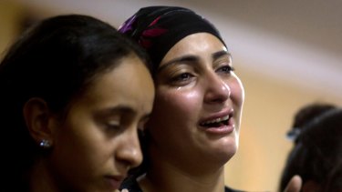 Relatives of Coptic Christians killed during a bus attack react during their funeral service, at Abu Garnous Cathedral in Minya, Egypt.