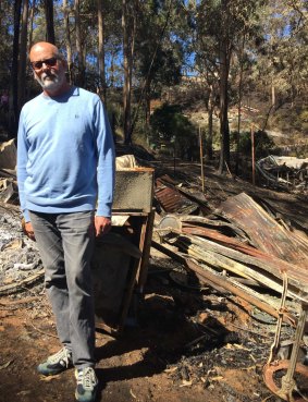 Andrew Holden in front of the destroyed home.