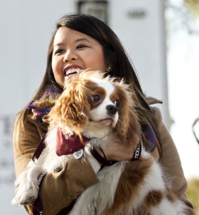 Nurse Nina Pham holds her dog Bentley at Hensley Field in Grand Prairie, Texas, after Bentley joined her in being declared Ebola-free.