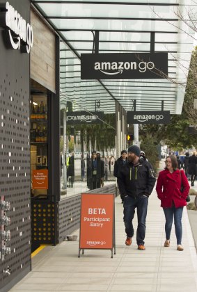 Pedestrians walk past the new Amazon.com Inc. Go grocery store in Seattle, Washington, US. Amazon's goal is to become a Top 5 grocery retailer by 2025,and could impact Australia's grocers.