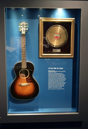 Slim Dustry's Gibson guitar  and gold record for <i>A Pub With No Beer</i> at the Slim Dusty Centre.