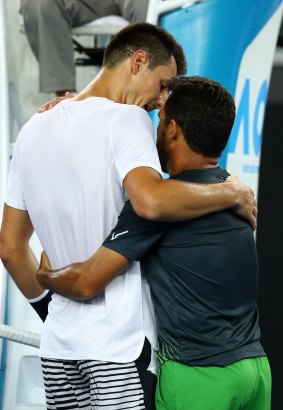Bernard Tomic and Victor Estrella Burgos embrace after their match.