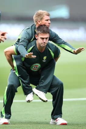 Countdown to the final: David Warner gets a ride from Mitch Marsh during an Australian nets session.