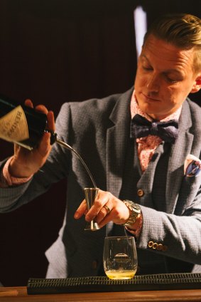 Sebastien Derbomez pours a Hendrick's gin cocktail in the Parlour of Curiosities at Hobart's Dark Mofo festival. 