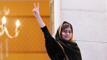 Nobel Peace Prize laureate Malala Yousafzai flashes a victory sign from the balcony of the Grand Hotel in Oslo in December last year.