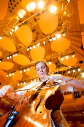 Catherine Hewgill, principal cellist in the Sydney Symphony Orchestra, plays under the new acoustic reflectors being tested in the Concert Hall of the Sydney Opera House.