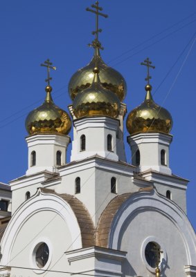 Golden domes of small Orthodox Church (next to Church of the Blood) at the Romanov Death Site, Russia.