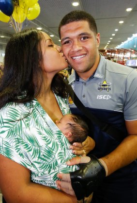 Left holding the baby: John Asiata with wife Shailah and daughter Eleana at Townsville airport on Sunday.
