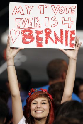 Lauren Esquivel displays a sign supporting Democratic presidential candidate Bernie Sanders in Miami on Tuesday.
