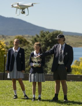 Snowy Mountains Grammar School students Ayumi Bailey (left), Jasmine Zollinger and Bode Townend work a drone.