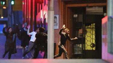 Hostages flee the Lindt Cafe during the siege on December 15, 2014.