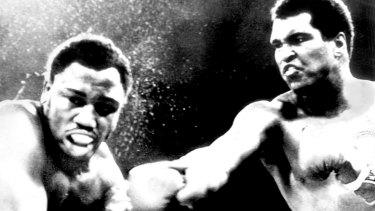 The champ: Muhammad Ali lands a punch on Joe Frazier the <i>Thrilla in Manilla</i> in 1975.
