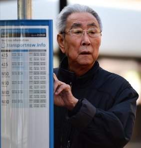 A man checks the timetable for a bus at Strathfield during the bus strike